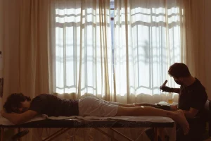 a man lying on a bed with a woman lying on the bed