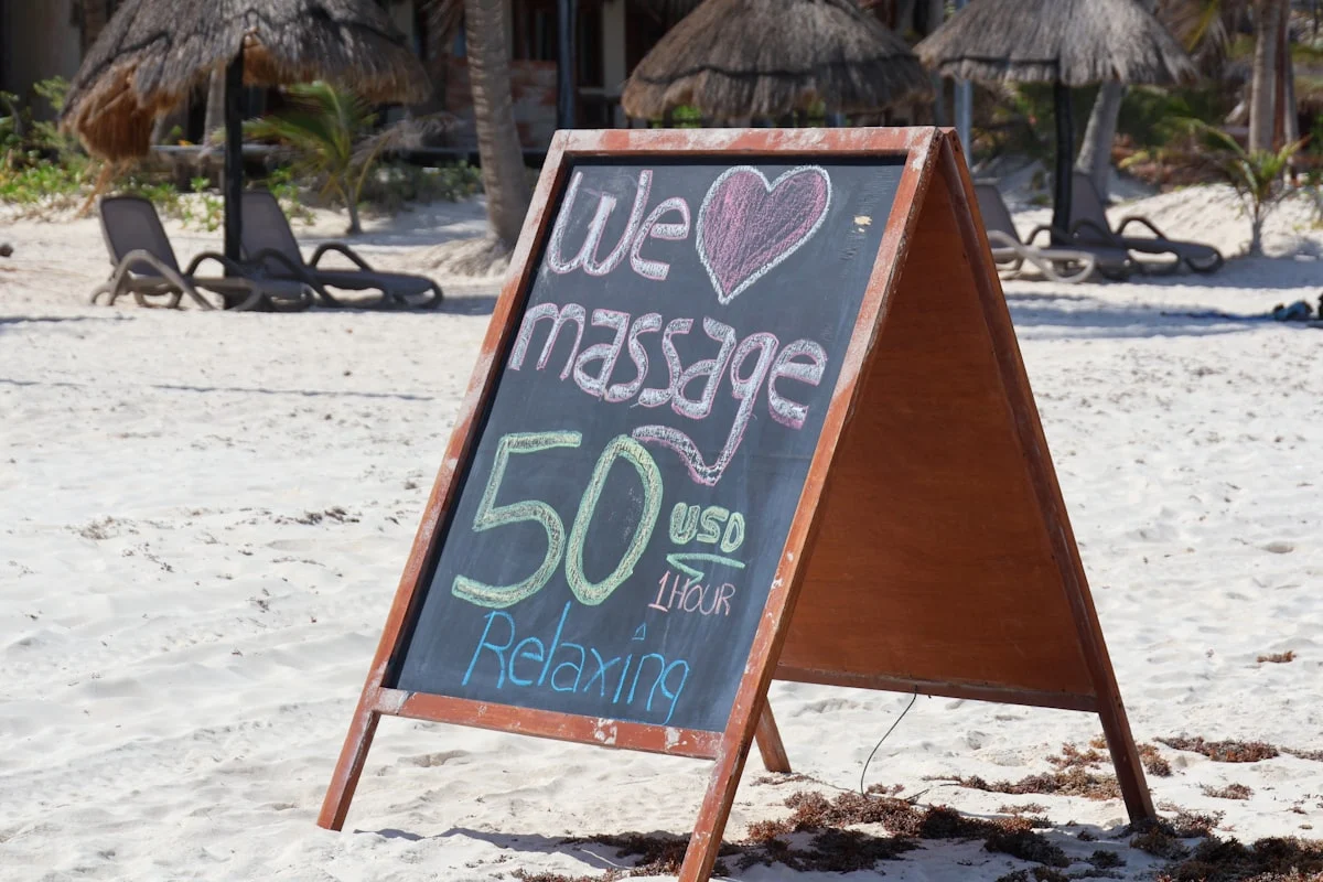 a sign on the beach that says we love massage