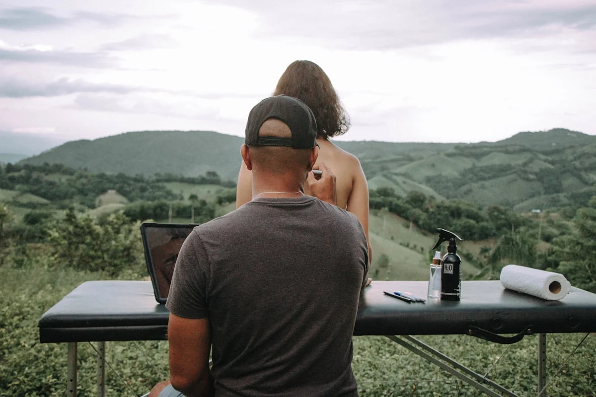 a man and a woman sitting at a table with a laptop