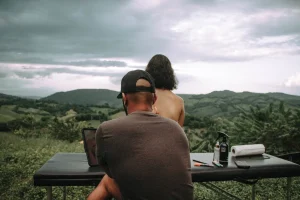 a man and a woman sitting at a picnic table