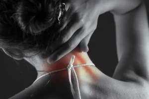 Acute pain in the back of a woman. Pain in the back and neck.