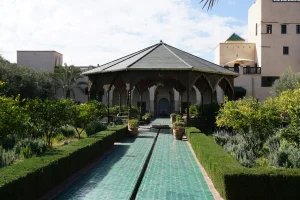 brown and white concrete building near green trees during daytime