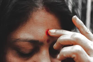 a close up of a person holding a cell phone to their ear