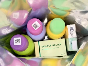 Colorful bottles and a box of patches inside a bag.