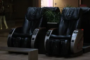 A couple of black chairs sitting on top of a hard wood floor